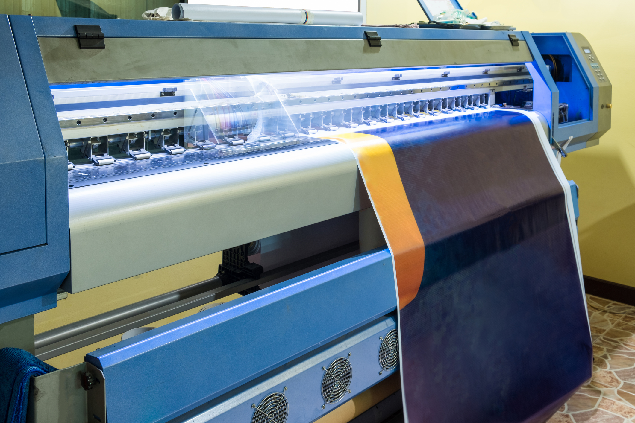 Large inkjet printer head working on blue vinyl